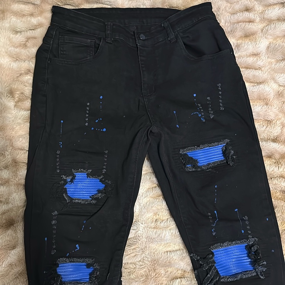 Men’s blue and black ripped jeans